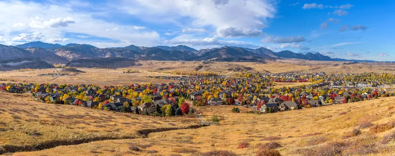 Autumn Foothill Village - A colorful panoramic Autumn day view of a small foothill neighborhood, as seen from North Table Loop Trail. Denver-Golden-Arvada, Colorado, USA.